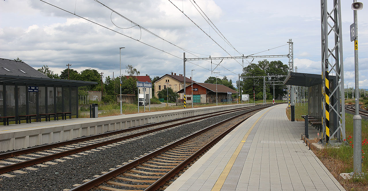 V roce 2024 svítila rok stará zastávka ještě novotou. Bezprostředně v pozadí je vidět skladiště <a href="/Tema/Bohosudov (žst)">stanice Bohosudov</a>, za stromem se skrývá výpravní budova.