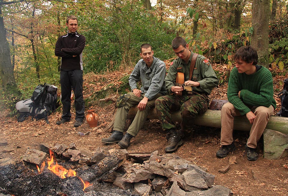 Brouk vysvětluje ostatním cosi o své kytaře Gibsonce.