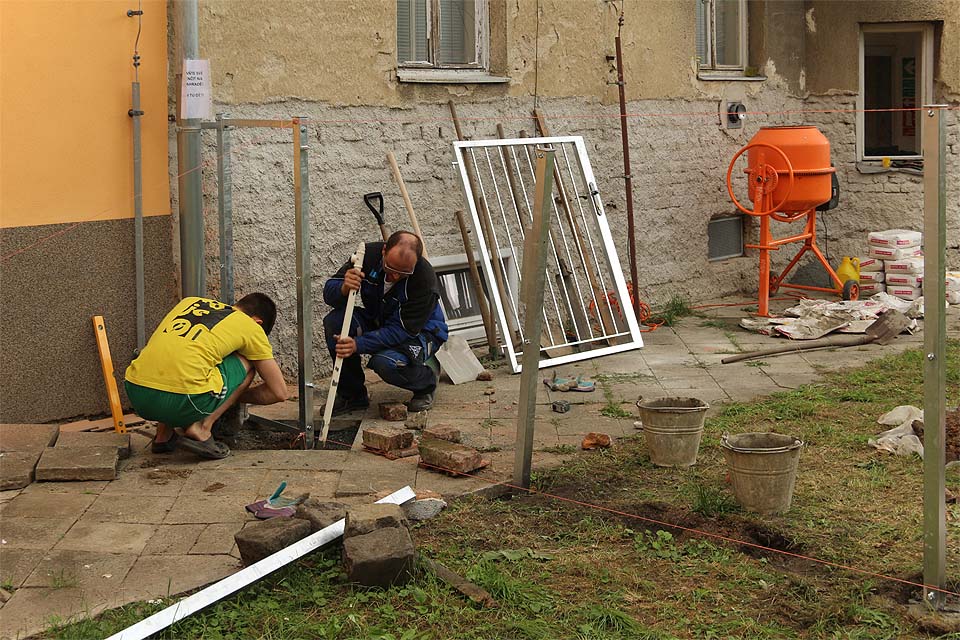 To je on - náš nový plot. Branka sice ještě leží opodál, ale už se těší na chvíli, která přijde záhy - zasazení do pantů.