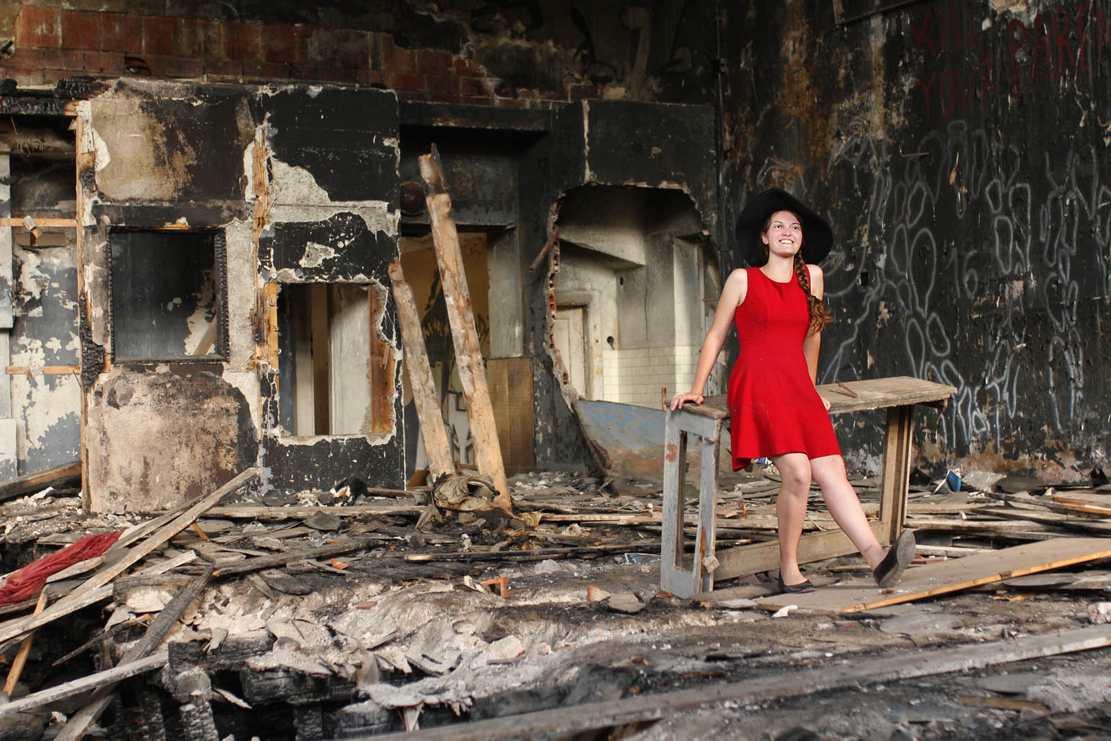 Ostře červené šaty na pozadí ohořelého jeviště v opušěném sále. Co může být krásnějšího? Už jedině Spyro sama.