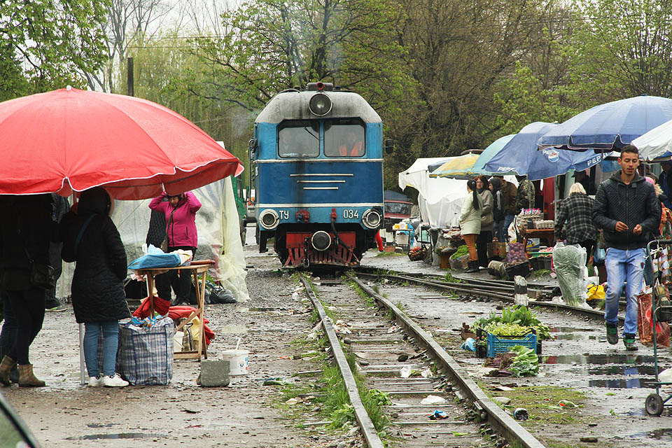 Po pěti minutách je kolej konečně volná a lokomotiva může projet. Připomíná nám to přeplněné uličky ve vietnamské Hanoji, kde se rychlíky proplétají mezi stánky a odpadky.