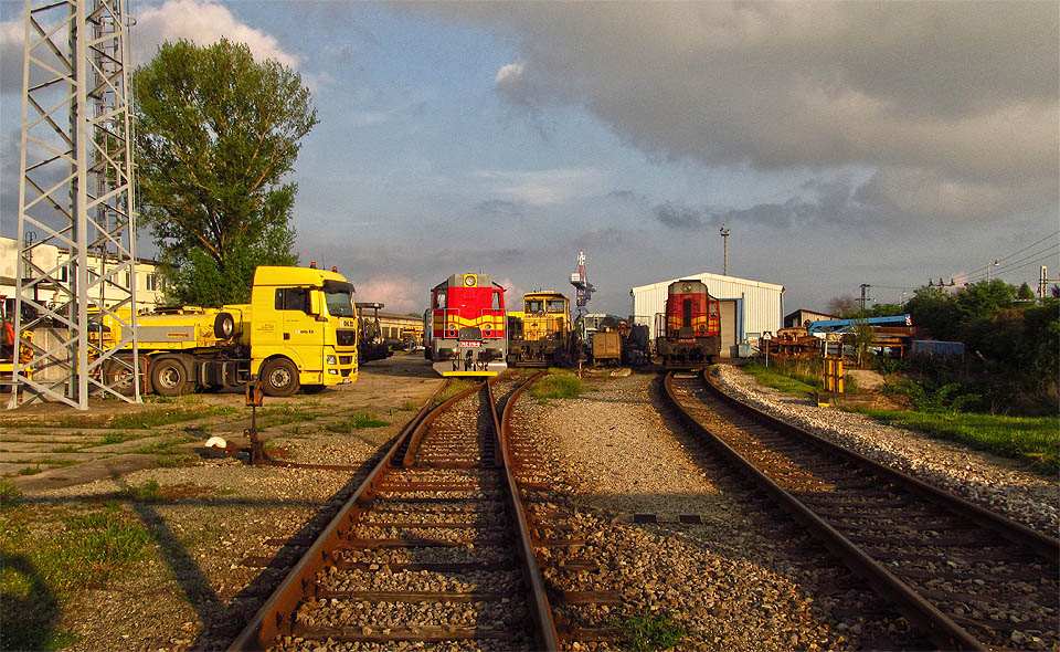 Silniční a drážní vozidla za branou si očividně rozumí.