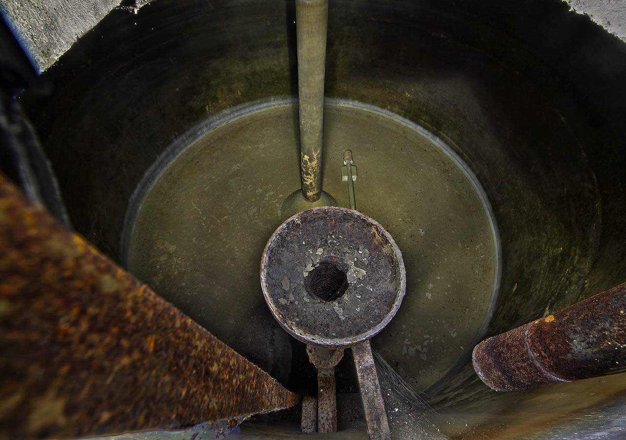 První pohled do válcové nádrže vodojemu přes nálevku, kterou odtékala voda z hladiny. Vpravo rezivějící napouštěcí trubka, vlevo žebřík pro sestup do hlubin.