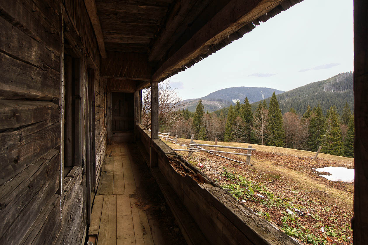 Dřevěná veradna prostředního domu skýtá vstup do příbytku, lidmi i bohem již před léty opuštěného.