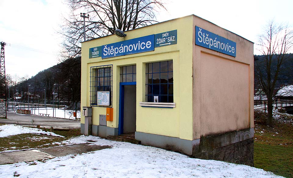 Barevná budova čekárny a zrušené výdejny jízdenek železniční zastávky Štěpánovice.