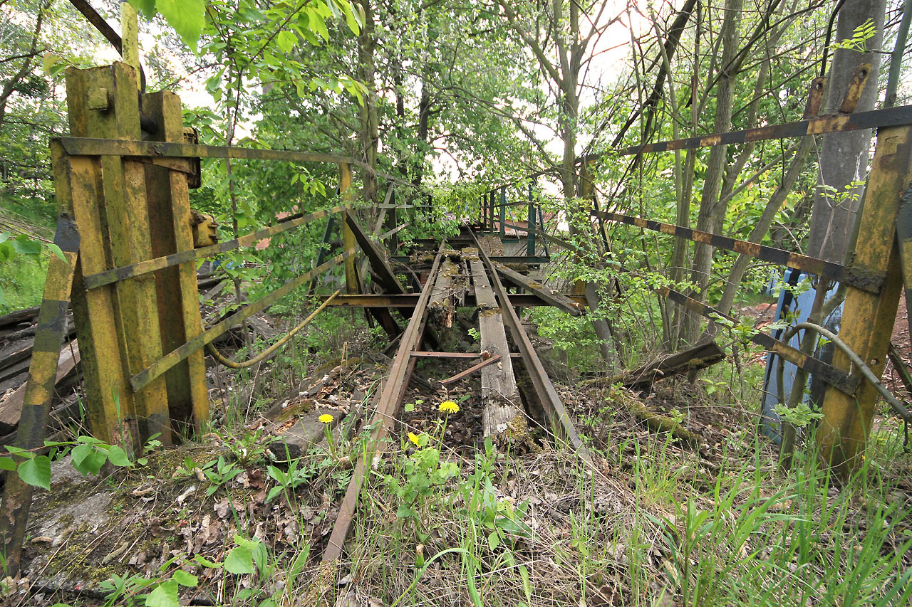 Koleje vedoucí z hliníku začínají přibližně 40 m před cihelnou stoupat po ocelovo-dřevěné rampě ke vratům do horního patra výrobní budovy.