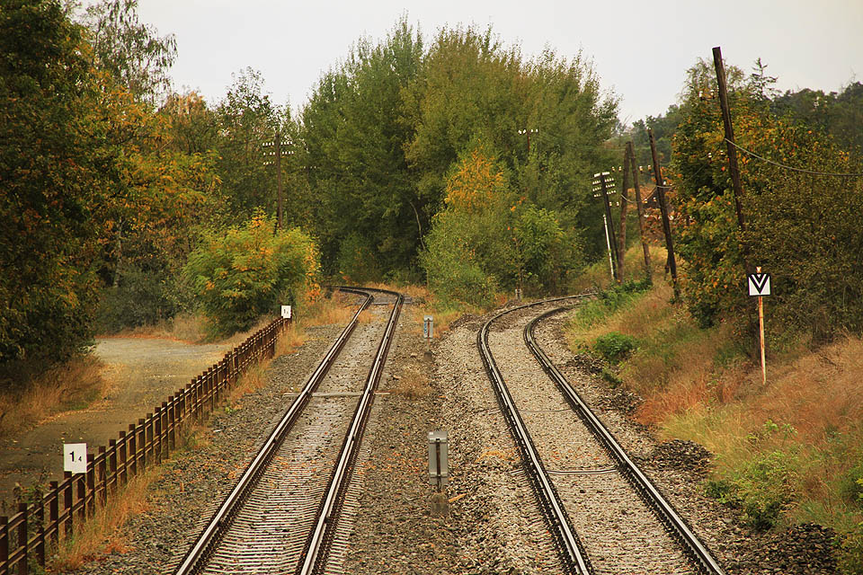 Ve vlečkovém km 1,5 se nad kamenolomem obě koleje konečně oddělují. Vpravo na hlavní trati stojí za pozornost méně obvyklá návěst č. 134: hranice pro návrat vozidel z širé trati.