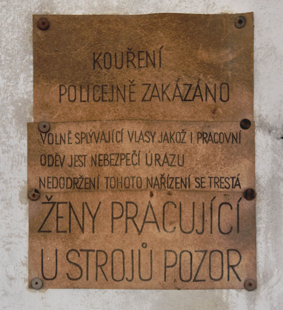 Kouření policejně zakázáno.<br>
Volně splývající vlasy jakož i pracovní oděv jest nebezpečí úrazu, nedodržení tohoto nařízení se trestá.<br>
Ženy pracující u strojů pozor!