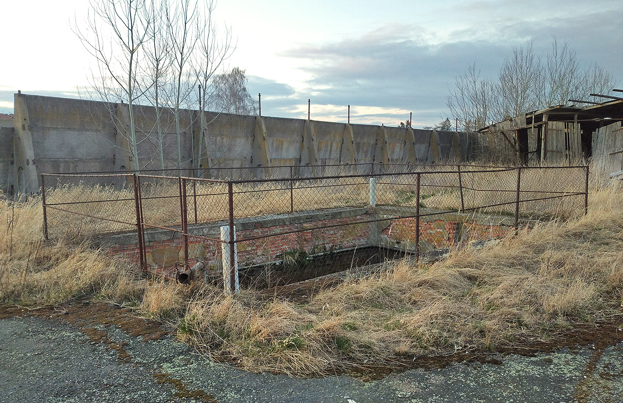 Jedna ze dvou nádrží v areálu. Černou tekutinu uvnitř neumíme spolehlivě pojmenovat.